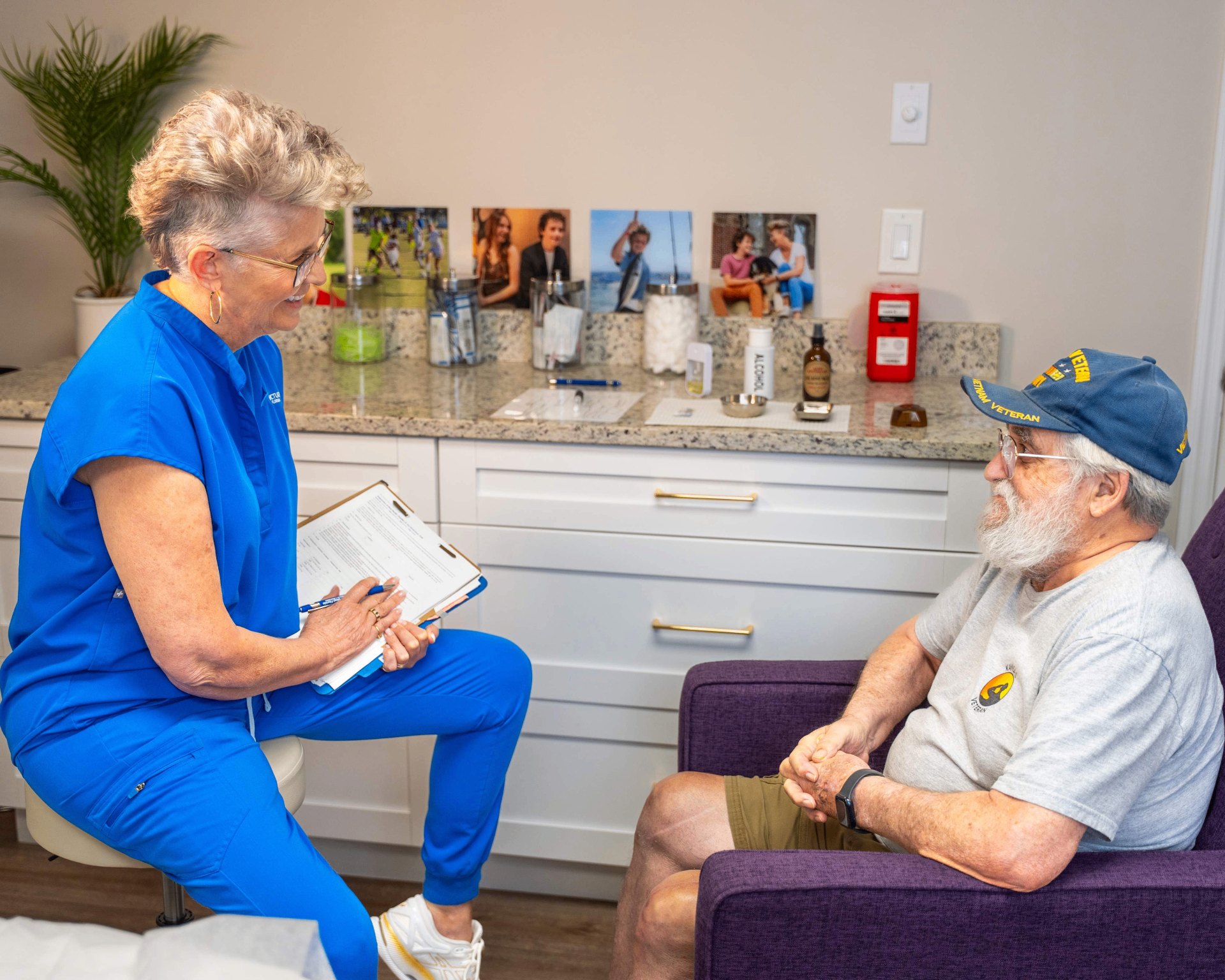 Dr. Kim Windschauer, AP, reviewing acupuncture treatment options with a U.S. military veteran during the Department of Defense–funded CARE study at Acupuncture of West Florida in Clearwater, FL.